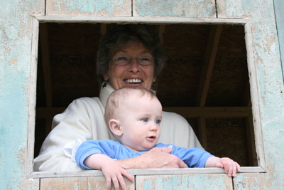 Nana and Max peeking out of the window in the door
